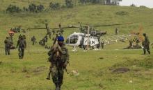 A U.N. helicopter lands near government troops at Kibumba the day after clashes against M23 rebels in the area outside the eastern Congolese city of Goma, July 25, 2012. PHOTO BY REUTERS/James Akena