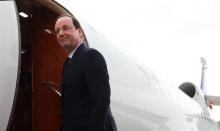 French President Francois Hollande boards his plane as he leaves Abuja, Nigeria's federal capital