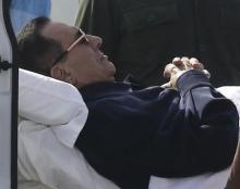 Former Egyptian President Hosni Mubarak lies on a stretcher while being transported ahead of his trial in Cairo, September 27, 2014. PHOTO BY REUTERS/Mohamed Abd El Ghany