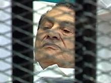 Former Egyptian President Hosni Mubarak is seen in the courtroom for his trial at the Police Academy in Cairo, in this still image taken from video