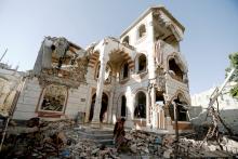 A guard walks in the yard of a house destroyed by air strikes in Sanaa, Yemen, March 21, 2018. PHOTO BY REUTERS/Khaled Abdullah