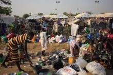 Displaced people prepare their meals at Tomping camp in Juba, where some 15,000 displaced people who fled their homes are sheltered by the United Nations