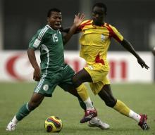 Ike Uche of Nigeria (L) is challenged by Benin's Abdul Adenon during their African Nations Cup Group B soccer match in Sekondi