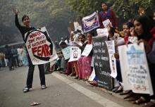 Protesters carry placards as they shout slogans during a protest to mark the first anniversary of the Delhi gang rape, in New Delhi