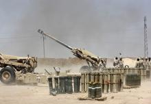 Iraqi security forces fire artillery during clashes with Sunni militant group Islamic State of Iraq and the Levant (ISIL) on the outskirts of the town of Udaim in Diyala province