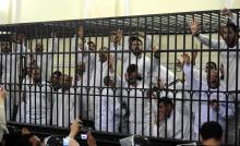 Supporters of the Muslim Brotherhood and ousted President Mohamed Mursi, standing trial on charges of violence that broke out in Alexandria last year, react after two fellow supporters were sentenced to death, in a court in Alexandria