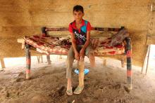 Ismail Abdullah, 12, who lost his leg in an air strike two years ago, poses for a photo in his hut at a camp for internally displaced people in Khamis of Hodeidah province, Yemen August 31, 2019. Picture taken August 31, 2019. PHOTO BY REUTERS/Eissa Alragehi 