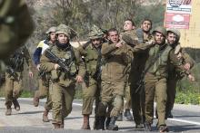 Israeli soldiers carry a wounded comrade on a stretcher near Israel's border with Lebanon, January 28, 2015. PHOTO BY REUTERS/JINIPIX