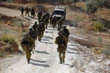 Israeli soldiers leave after an operation near the West Bank village of Bilin, near Ramallah