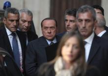 Italy's former prime minister Silvio Berlusconi (C) arrives at the lower house of parliament in Rome
