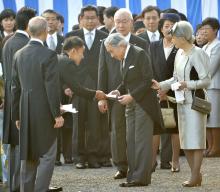 Japanese lawmaker Taro Yamamoto (3rd L) hands a letter to Emperor Akihito (front C), while Empress Michiko (R) looks on, during the annual autumn garden party