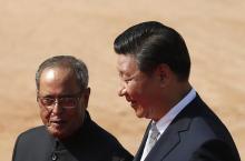 China's President Xi Jinping (R) speaks with his Indian counterpart Pranab Mukherjee during his ceremonial reception at the forecourt of India's Rashtrapati Bhavan presidential palace in New Delhi, September 18, 2014. PHOTO BY REUTERS/Ahmad Masood