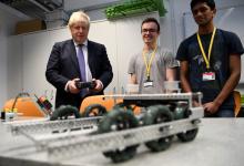 Britain's Prime Minister Boris Johnson uses a robot built by students during his visit to King's Maths School, part of King's College London University, in central London, Britain January 27, 2020. PHOTO BY REUTERS/Daniel Leal-Olivas