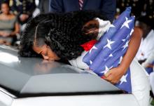 Myeshia Johnson, wife of U.S. Army Sergeant La David Johnson, who was among four special forces soldiers killed in Niger, kisses his coffin at a graveside service in Hollywood, Florida, October 21, 2017. REUTERS/Joe Skipper