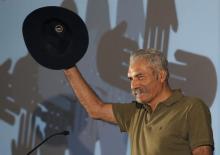 Jose Manuel Mireles, coordinator of the vigilante groups of the state of Michoacan, greets the audience during a meeting of leaders of vigilante groups in Mexico City