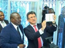 President Joseph Kabila of the Democratic Republic of Congo (L) alongside Semlex CEO Albert Karaziwan during an event to launch the country's new biometric passports at the foreign ministry in Kinshasa in this still image taken from footage shot in November 2015. PHOTO BY REUTERS/RTNC