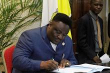 Congolese opposition party Reformist Forces for Union and Solidarity (FONUS) Joseph Olenga Nkoy signs the accord between the opposition and the government of President Joseph Kabila at the Conference episcopale nationale du Congo (CENCO) headquarters in Gombe Municipality, of the Democratic Republic of Congo's capital Kinshasa, December 31, 2016. PHOTO BY REUTERS/Kenny Katombe