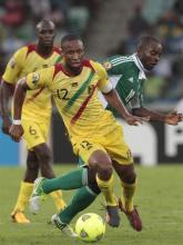 Mali's captain Seydou Keita (12) dribbles the ball away from Nigeria's Sunday Mba during their African Cup of Nations (AFCON 2013) semi-final soccer match at the Moses Mabhida stadium in Durban