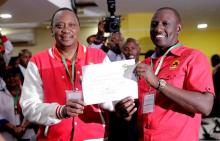 Kenya's President Uhuru Kenyatta (L) of the Jubilee Party and his Deputy William Ruto display their clearance certificate from the Independent Electoral and Boundaries Commission (IEBC) after presenting their candidacy for the presidential race in Nairobi, Kenya, May 29, 2017. PHOTO BY REUTERS/Thomas Mukoya