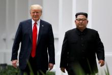 U.S. President Donald Trump and North Korean leader Kim Jong Un walk after lunch at the Capella Hotel on Sentosa island in Singapore, June 12, 2018. PHOTO BY REUTERS/Jonathan Ernst