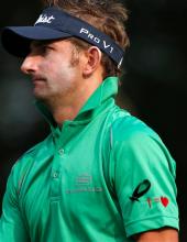 Jbe Kruger from South Africa, wearing a black ribbon in memory of the late South African anti-apartheid hero Nelson Mandela, walks on the 11th fairway during the third day of the European Tour Hong Kong Open golf tournament