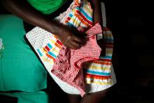 Lenzer Achieng, the mother of six-month-old Samantha Pendo who died during an August 2017 police crackdown on opposition supporters, holds her daughter's clothes inside her home, in the western city of Kisumu, Kenya, January 25, 2018. PHOTO BY REUTERS/Baz Ratner