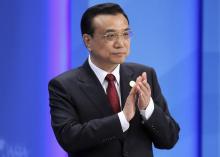 Chinese Premier Li Keqiang claps as he attends the opening ceremony of the Boao Forum for Asia (BFA) Annual Conference 2014 in Boao, Hainan province