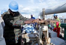 South Sudan's Minister of Petroleum, Ezekiel Lol Gatkuoth, turns a spigot at an oil well at the Toma South oil field to Heglig, in Ruweng State, South Sudan, August 25, 2018. PHOTO BY REUTERS/Jok Solomun
