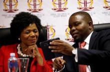 Outgoing South African Public Protector, Thuli Madonsela chats to her deputy, Kevin Malunga in Pretoria, South Africa, October 14, 2016. PHOTO BY REUTERS/Siphiwe Sibeko