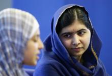 Malala Yousefzai (R) listens to 17 year old Syrian refugee Muzoon Almellehan speak to journalists at the City Library in Newcastle Upon Tyne, Britain, December 22, 2015. PHOTO BY REUTERS/Darren Staples