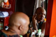 LGBT activist Phelix Kasanda, also known as Mama G, puts on make up before an interview with Reuters in Nairobi, Kenya, February 14 , 2019. PHOTO BY REUTERS/Baz Ratner