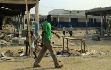 A man walks past burnt-out shops in Malakal, 497 km (308 miles) northeast of capital Juba