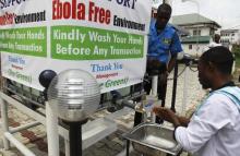 A man washes his hands at a tap outside the Green Pharmacy, Area 8, in Abuja, September 1, 2014. PHOTO BY REUTERS/Afolabi Sotunde