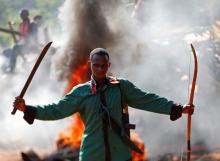 A man gestures in front of a burning barricade during a protest against French soldiers in Bambari, May 22, 2014. PHOTO BY REUTERS/Goran Tomasevic