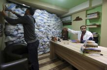 A man gestures towards sandbags piled as protection from future explosions at a stronghold of the Shi'ite group Hezbollah in the southern suburbs of the Lebanese capital Beirut