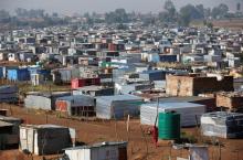 A man is seen walking at an informal settlement located next to Lenasia, south of Johannesburg, South Africa, May 30, 2018. PHOTO BY REUTERS/Siphiwe Sibeko