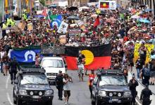 Police escort people joining a march with Aboriginal protesters on Australia Day in central Brisbane, Australia, January 26, 2017. PHOTO BY REUTERS/Dan Peled