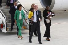 Mariam Yahya Ibrahim of Sudan (R) carries one of her children as she arrives with Lapo Pistelli (C), Italy's vice minister for foreign affairs, holding her other child, and his wife Agnese (L in green) after landing at Ciampino airport in Rome