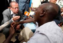 U.N. Special Representative and Head of the United Nations Support Mission in Libya Martin Kobler speaks to one of the illegal immigrants during his visit to Abu Saleem detention center for illegal immigrants in Tripoli, May 19, 2016. PHOTO BY REUTERS/Ismail Zitouny