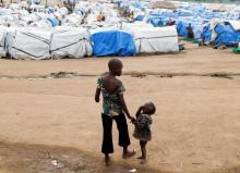 Mave Grace, 11, who had part of her arm chopped off by militiamen when they attacked the village of Tchee, walks with her sister Racahele-Ngabausi, aged two, in an Internally Displaced Camp in Bunia, Ituri province, eastern Democratic Republic of Congo, April 12, 2018. PHOTO BY REUTERS/Goran Tomasevic