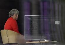 Britain's Prime Minister Theresa May is seen through a window as she is interviewed on the BBC's Andrew Marr Show during the Conservative Party Conference in Birmingham, Britain, September 30, 2018. PHOTO BY REUTERS/Toby Melville