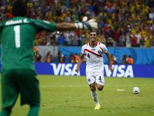 Costa Rica's Michael Umana celebrates with goalkeeper Keilor Navas after scoring the decisive penalty during a penalty shootout