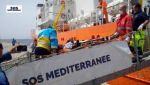 A migrant receives help when disembarking from the SOS Mediterranee ship Aquarius at the Italian island of Lampedusa, April 18, 2016. PHOTO BY REUTERS/SOS Mediterranee 