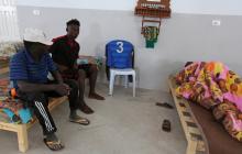 An African migrant (C), who was rescued after the boat he was travelling capsized in the Mediterranean Sea off the Tunisian Coast, sits inside a local Red Crescent chapter in Zarzis, Tunisia July 4, 2019. PHOTO BY REUTERS/Stringer 