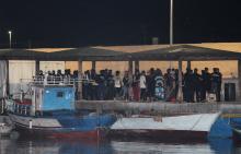 Migrants gather at the port in Lampedusa after the Italian government allowed the disembarkation of 82 migrants on board the rescue ship Ocean Viking, Italy, September 14, 2019. PHOTO BY REUTERS/Mauro Buccarello