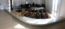 Coffins carrying the bodies of migrant women who drowned in a shipwreck in the Mediterranean Sea are seen laid out in a hall on the island of Lampedusa, Italy, October 8, 2019. PHOTO BY REUTERS/Vladimiro Pantaleone