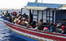 Illegal migrants who attempted to sail to Europe, sit in a boat carrying them back to Libya, after their boat was intercepted at sea by the Libyan coast guard, at Khoms, Libya, May 6, 2015. PHOTO BY REUTERS/Aymen Elsahli