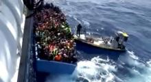 A boat full of migrants is seen next to Swedish ship Poseidon during a rescue operation in the sea off the coast of Libya in this still image taken from an August 26, 2015 video. PHOTO BY REUTERS/Swedish Coast Guard Handout via Reuters TV