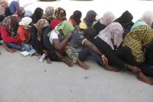 Illegal migrants sit at temporary detention centre after they were detained by Libyan authorities in Tripoli, Libya, October 12, 2015. PHOTO BY REUTERS/Ismail Zitouny