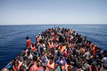 Migrants crowd the deck of their wooden boat off the coast of Libya May 14, 2015. PHOTO BY REUTERS/MOAS/Jason Florio